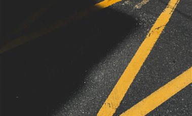 Road Marking Paints & Reflective Materials Yellow road marking lines painted on asphalt