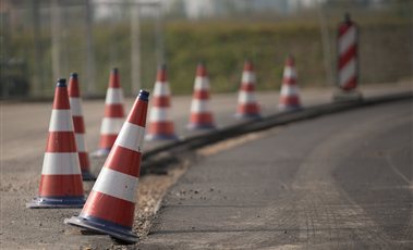 Traffic Safety Equipment Row of red and white traffic cones along a road under construction
