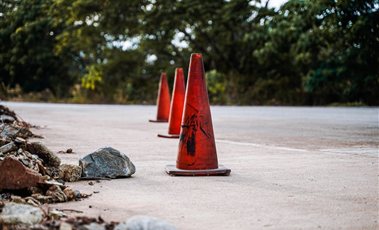 Orange traffic cones placed on a road to guide traffic